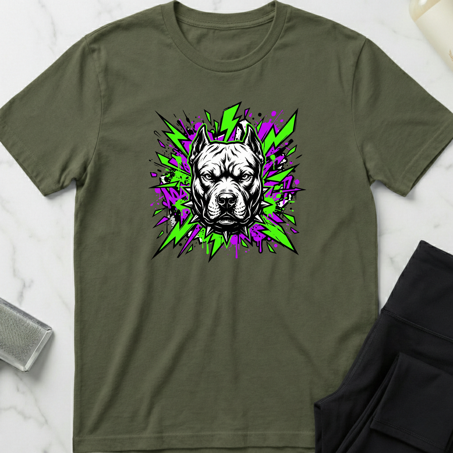 Green t-shirt with a dog graphic on a marble surface. Minimalist dog apparel by pemuyo.