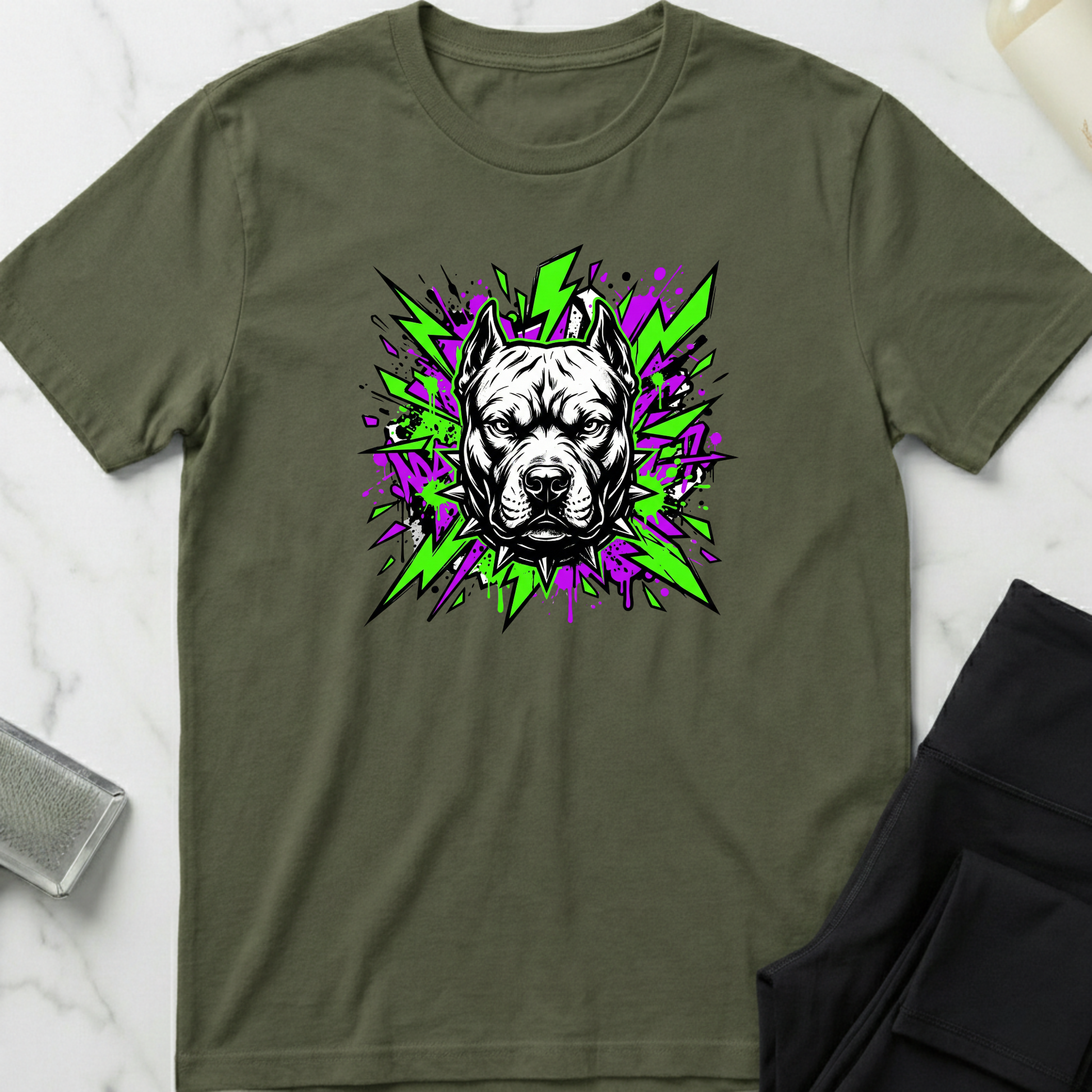 Green t-shirt with a dog graphic on a marble surface. Minimalist dog apparel by pemuyo.