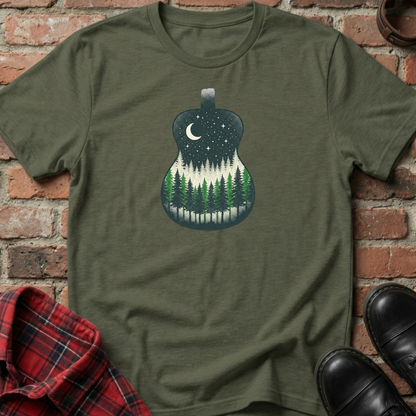 Green t-shirt with a guitar-shaped forest design on a brick background. Minimalist music apparel by pemuyo.