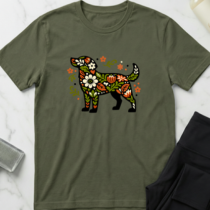 Green t-shirt with a colorful floral dog design on a marble surface. Minimalist dog apparel by pemuyo.