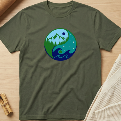 Green t-shirt with a nature-themed graphic on a wooden surface. Minimalist yoga apparel by pemuyo.