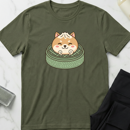 Green t-shirt with a cartoon dog design on a marble surface. Minimalist dog apparel by pemuyo.