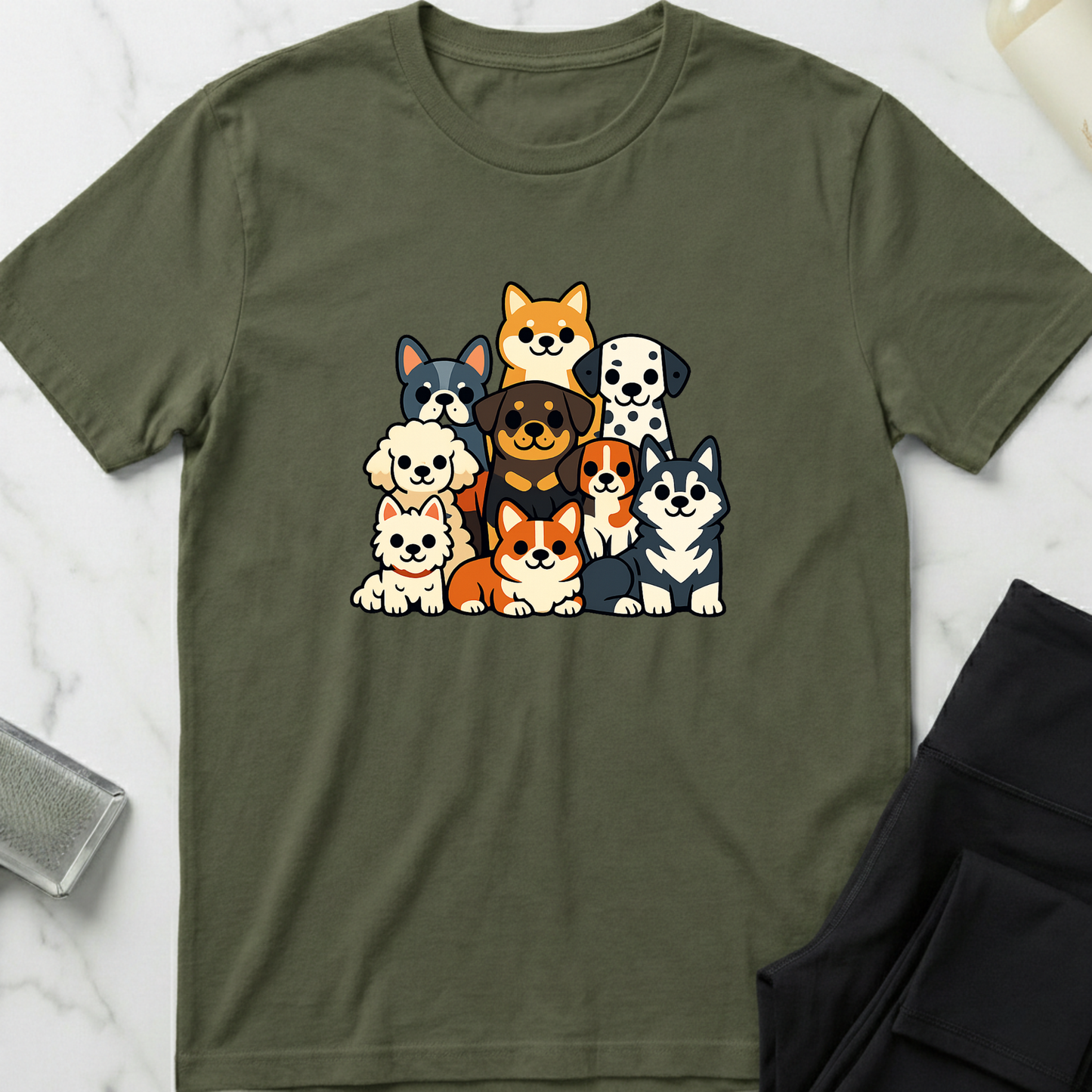 Green t-shirt with cartoon dog illustrations on a white marble surface. Minimalist dog apparel by pemuyo.