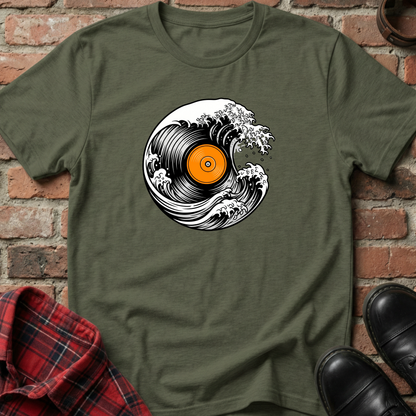 Green t-shirt with vinyl record design on a brick wall background. Minimalist music apparel by pemuyo.