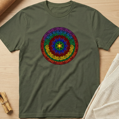 Green t-shirt with a colorful mandala design on a wooden surface. Minimalist yoga apparel by pemuyo.