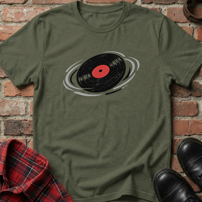 Green t-shirt with a vinyl record design on a brick background. Minimalist music apparel by pemuyo.