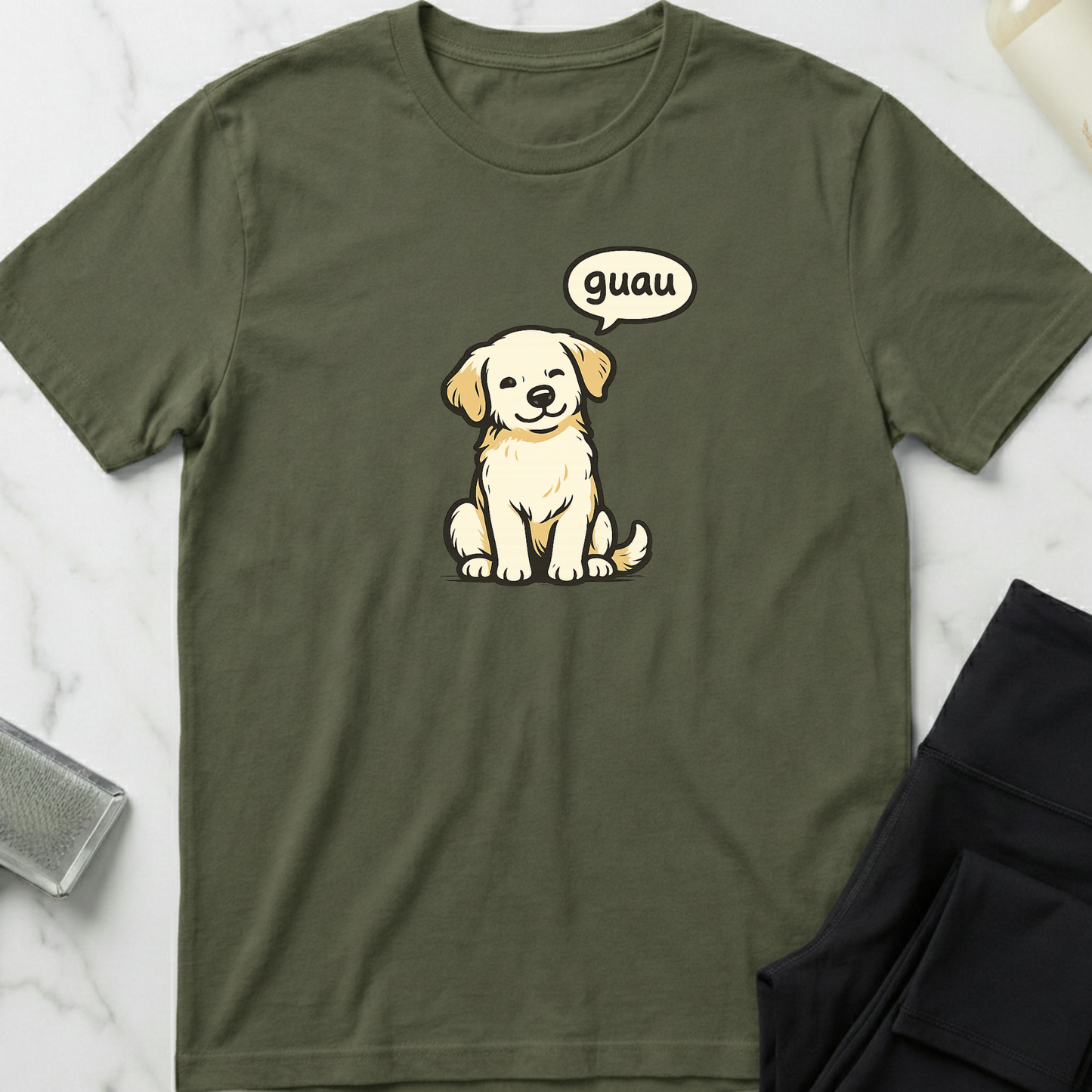 Green t-shirt with a cartoon dog and 'guau' speech bubble on a marble surface. Minimalist dog apparel by pemuyo.