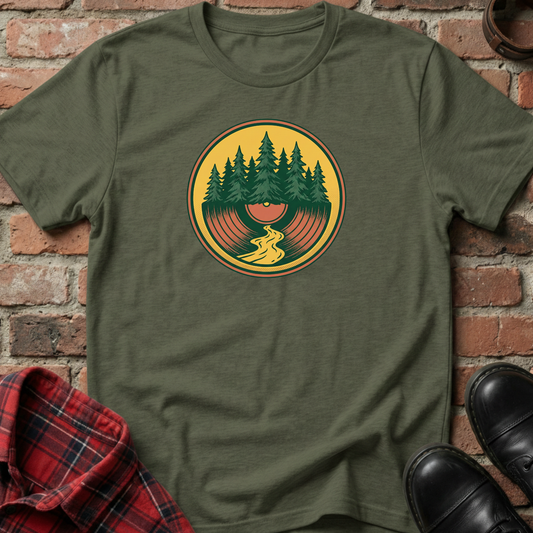 Green t-shirt with a nature graphic on a brick background. Minimalist music apparel by pemuyo.