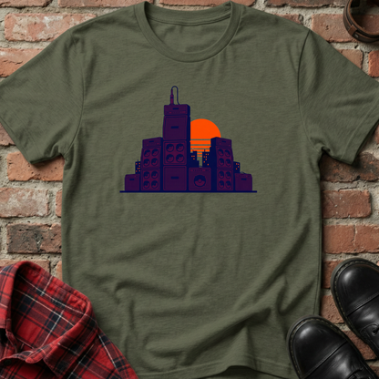 Green t-shirt with cityscape design on a brick wall background. Minimalist music apparel by pemuyo.