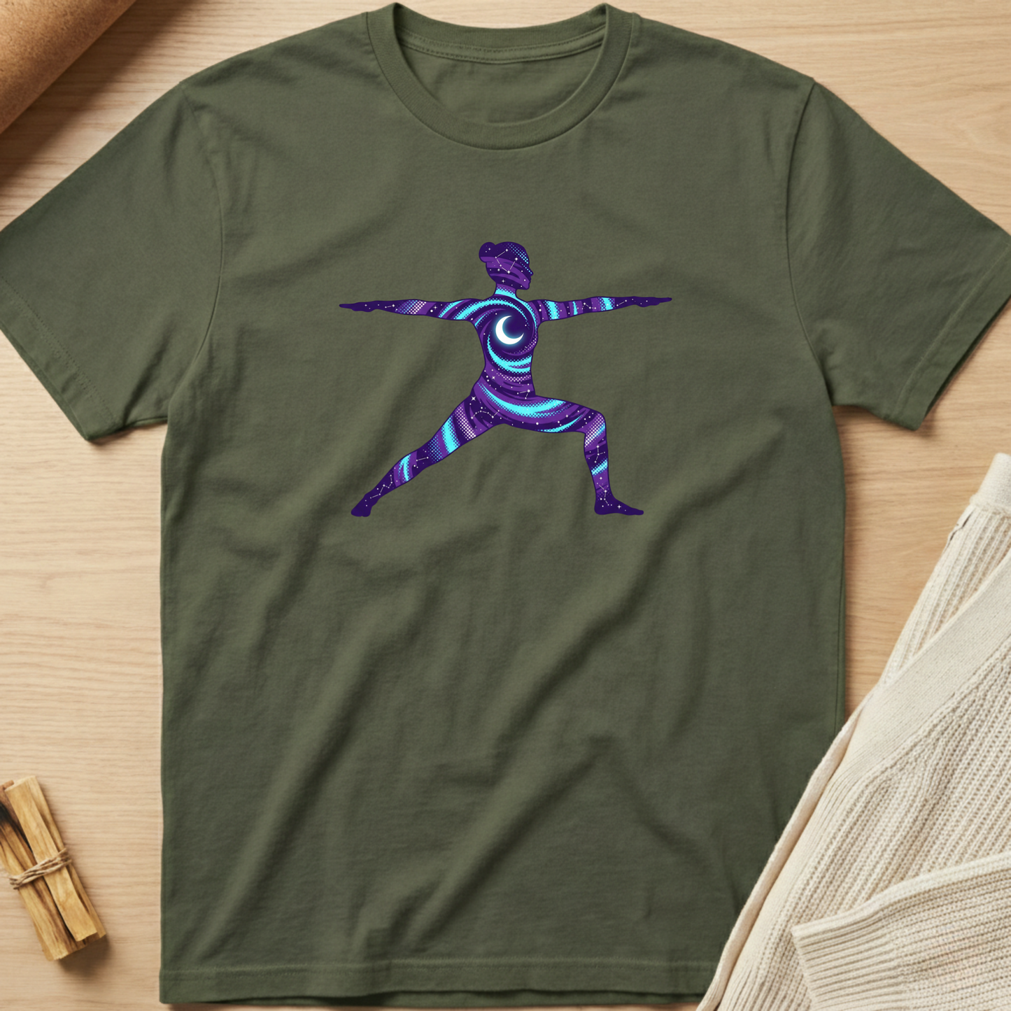 Green t-shirt with a colorful abstract design on a wooden surface. Minimalist yoga apparel by pemuyo.