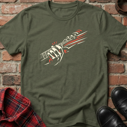 Green t-shirt with a graphic design of a gun and two people on a brick background. Minimalist music apparel by pemuyo.