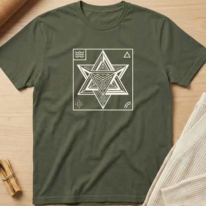 Green t-shirt with a geometric star design on a wooden surface. Minimalist yoga apparel by pemuyo.