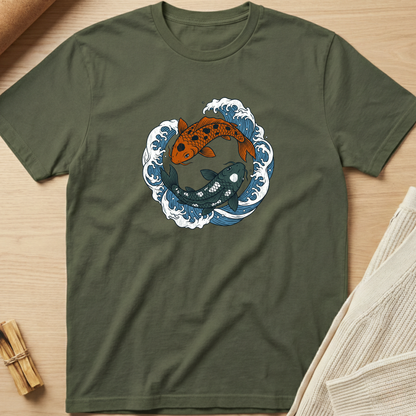 Green t-shirt with koi fish design on a wooden surface. Minimalist yoga apparel by pemuyo.