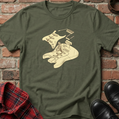 Green t-shirt with a graphic design of a person playing a guitar on a brick surface. Minimalist music apparel by pemuyo.