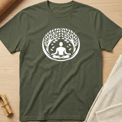 Green t-shirt with a white meditation design on a wooden surface. Minimalist yoga apparel by pemuyo.