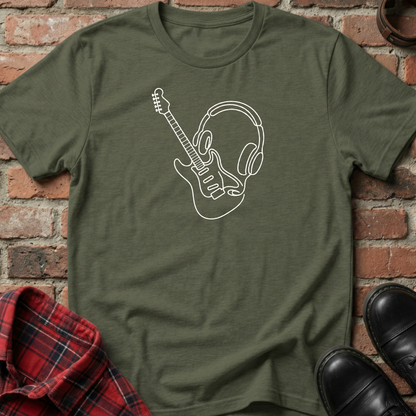 Green t-shirt with a white graphic design of a guitar and headphones on a brick background. Minimalist music apparel by pemuyo.
