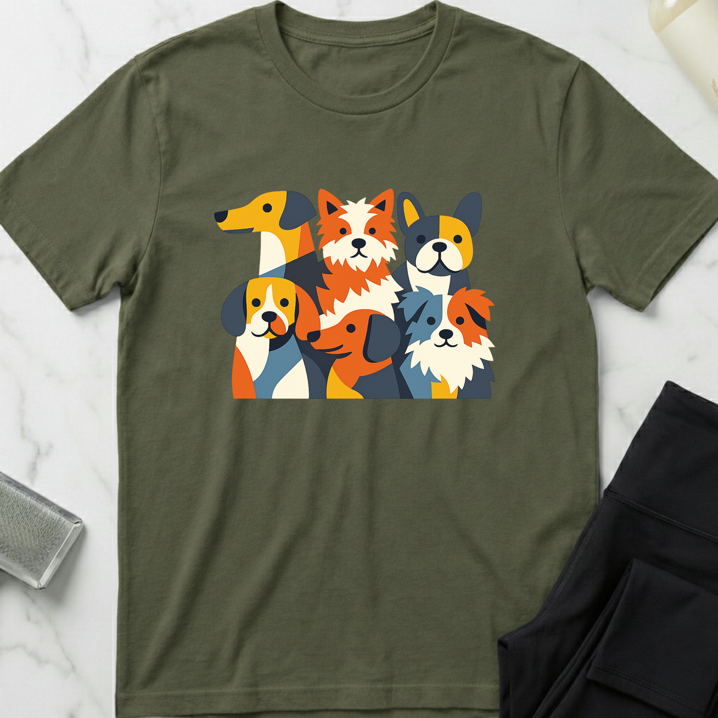 Green t-shirt with colorful dog graphic on a marble surface. Minimalist dog apparel by pemuyo.