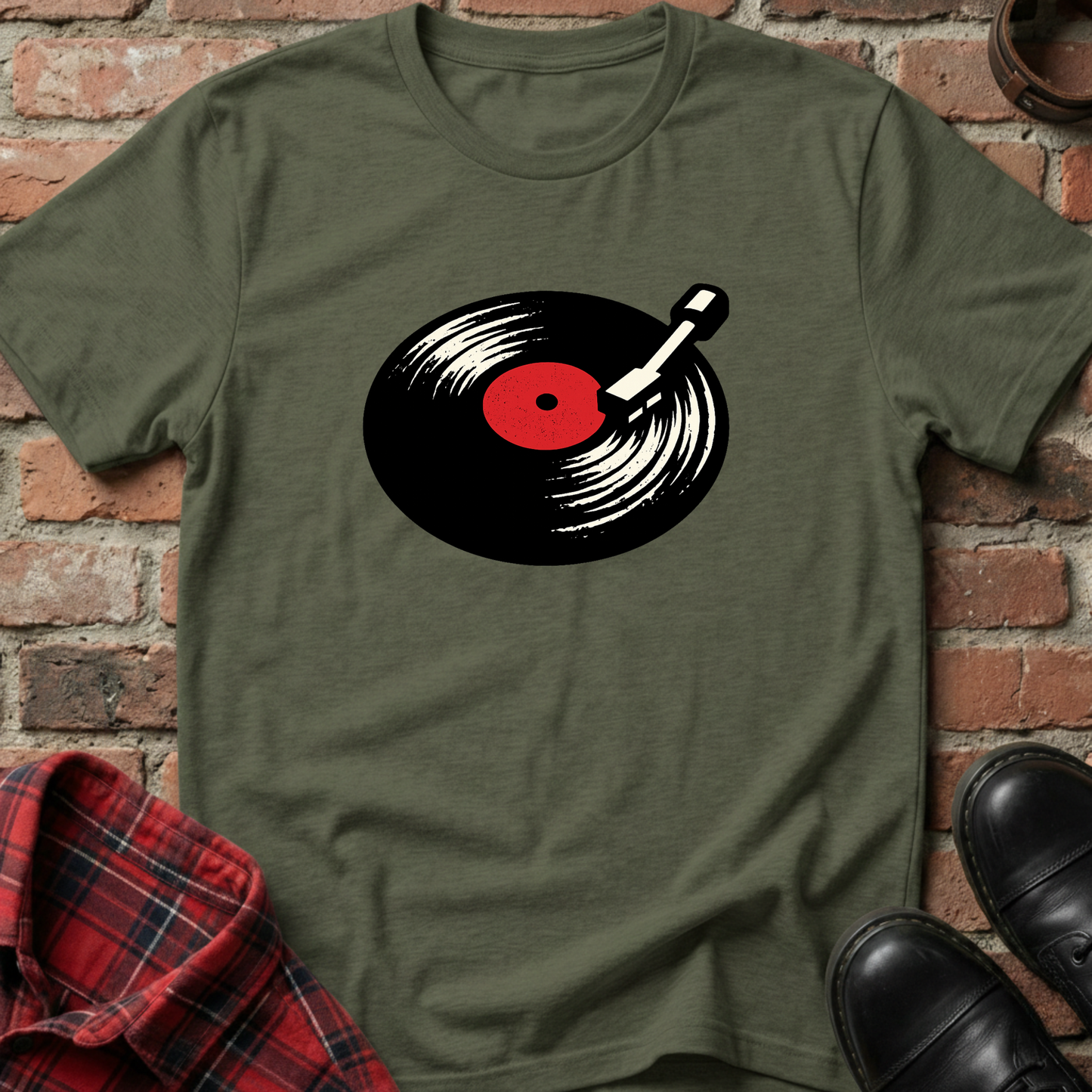Green t-shirt with a vinyl record design on a brick background. Minimalist music apparel by pemuyo.