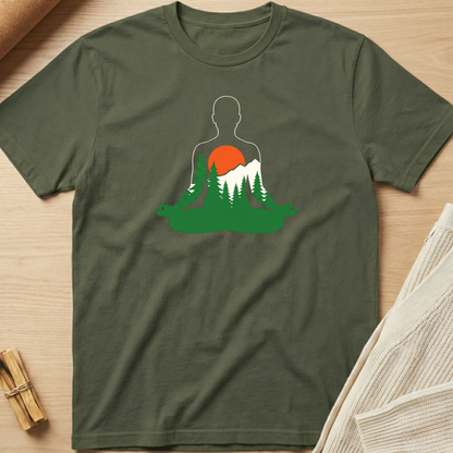 Green t-shirt with a nature-themed graphic on a wooden surface. Minimalist yoga apparel by pemuyo.