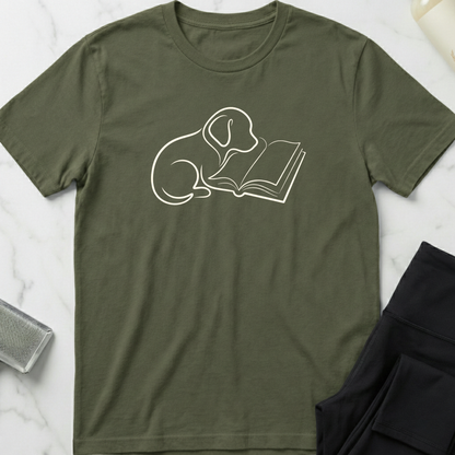 Green t-shirt with a white line drawing of a dog reading a book on a marble surface. Minimalist dog apparel by pemuyo.