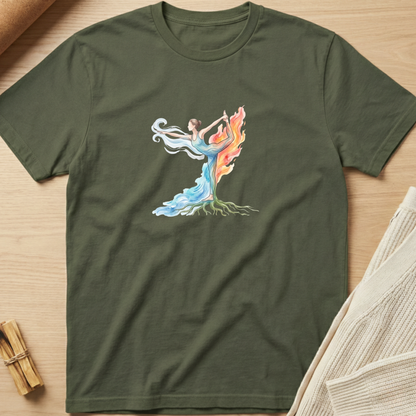 An olive green short-sleeve t-shirt with a colorful graphic of a dancing female figure with roots and flowing blue, white, and orange flames, laid flat on a light wood background. Minimalist yoga apparel by pemuyo.