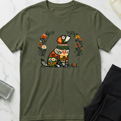 Green t-shirt with a colorful dog and floral design on a marble surface. Minimalist dog apparel by pemuyo.
