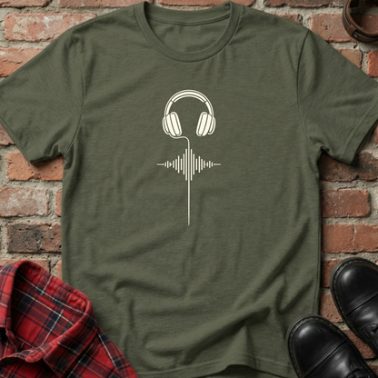 Green t-shirt with headphones and sound wave design on a brick background. Minimalist music apparel by pemuyo.