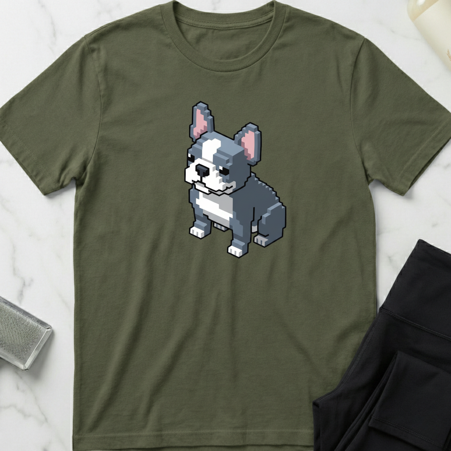 Green t-shirt with a pixelated dog graphic on a marble surface. Minimalist dog apparel by pemuyo.