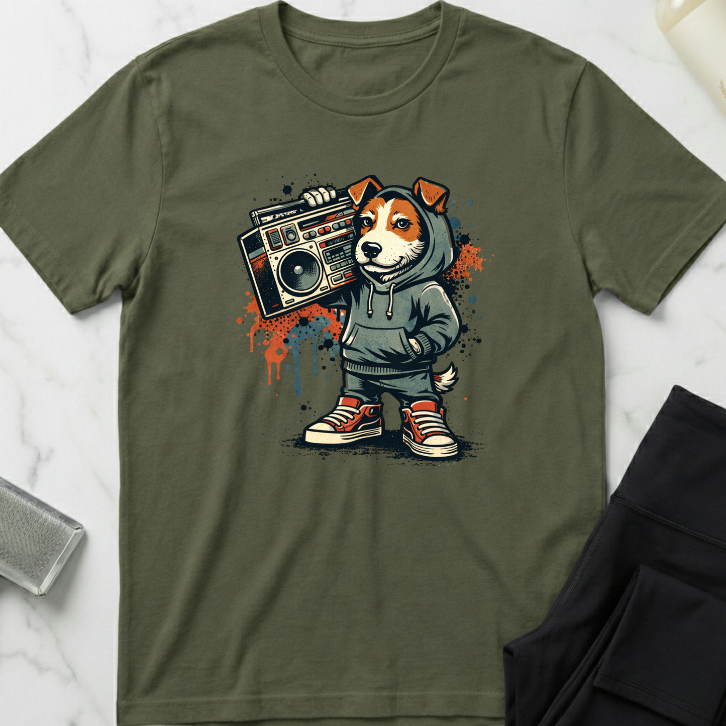 Green t-shirt with a graphic of a dog in a hoodie holding a boombox on a white marble surface. Minimalist dog apparel by pemuyo.