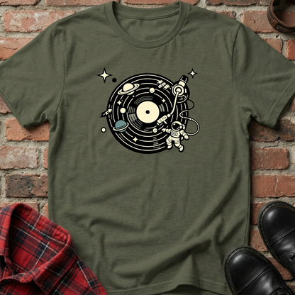 Green t-shirt with space-themed design on a brick wall background. Minimalist music apparel by pemuyo.