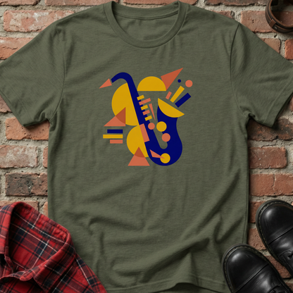 Green t-shirt with geometric saxophone design on a brick background. Minimalist music apparel by pemuyo.