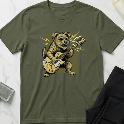 Green t-shirt with a dog playing guitar graphic on a marble surface. Minimalist dog apparel by pemuyo.