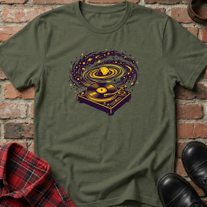 Green t-shirt with a graphic design of a turntable and vinyl record on a brick background. Minimalist music apparel by pemuyo.