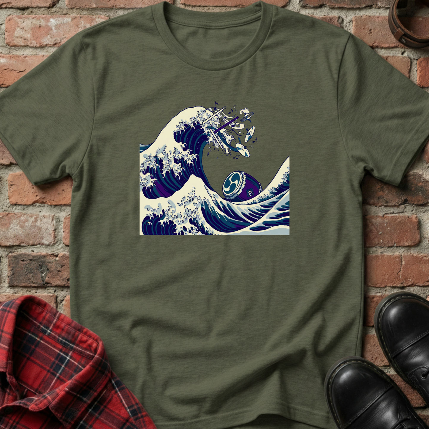 Green t-shirt with wave design on a brick wall background. Minimalist music apparel by pemuyo.
