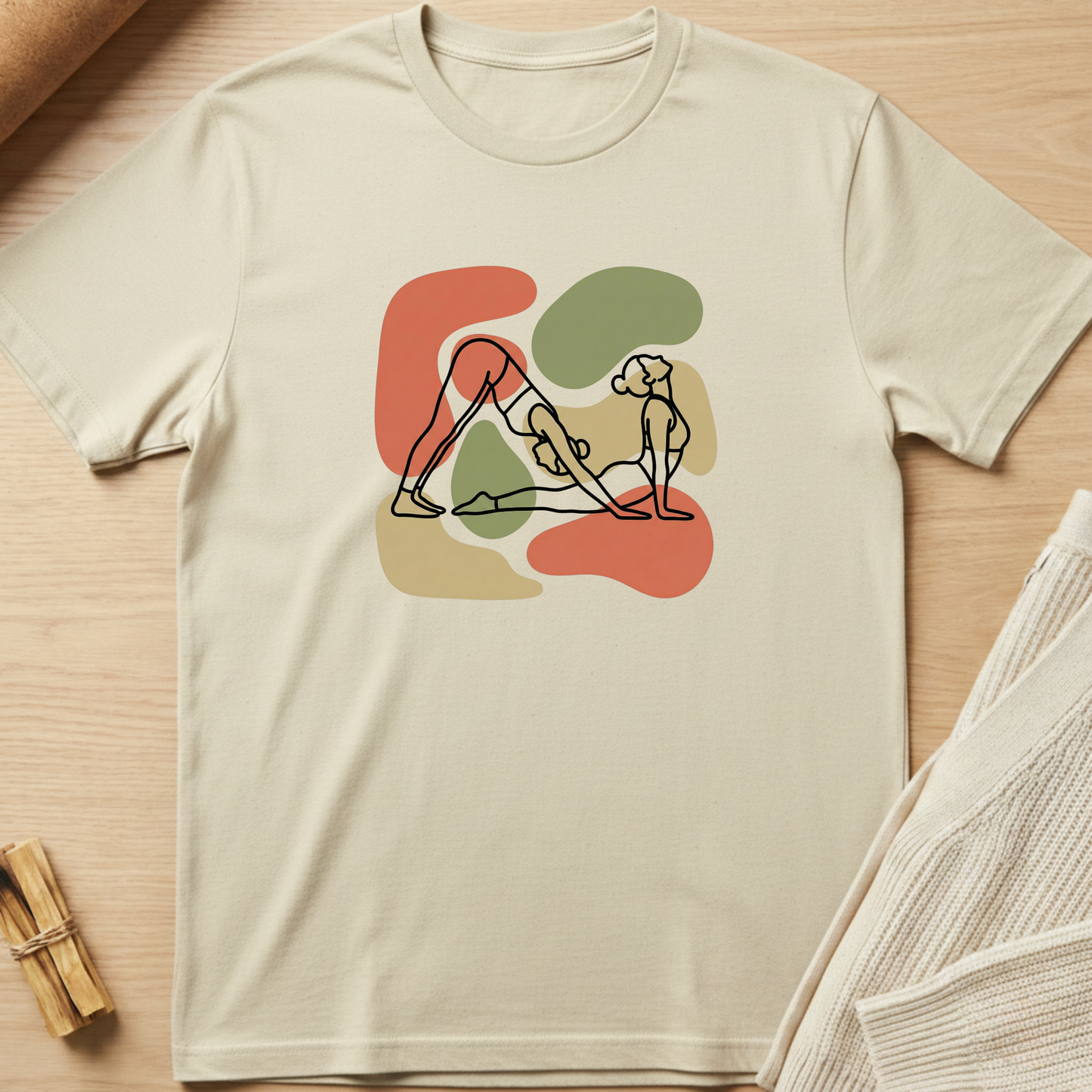 Beige t-shirt with abstract design on a wooden surface. Minimalist yoga apparel by pemuyo.