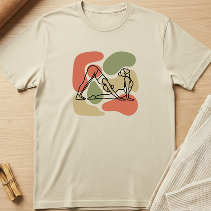 Beige t-shirt with abstract design on a wooden surface. Minimalist yoga apparel by pemuyo.