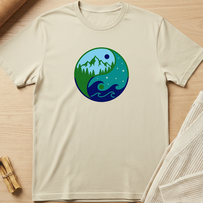 Beige t-shirt with a circular design featuring nature elements on a wooden surface. Minimalist yoga apparel by pemuyo.