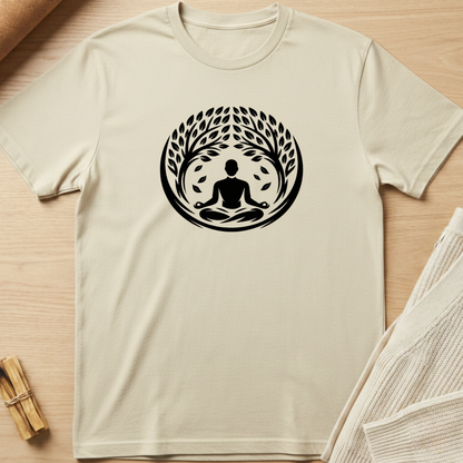 Beige t-shirt with a black meditation graphic on a wooden surface. Minimalist yoga apparel by pemuyo.