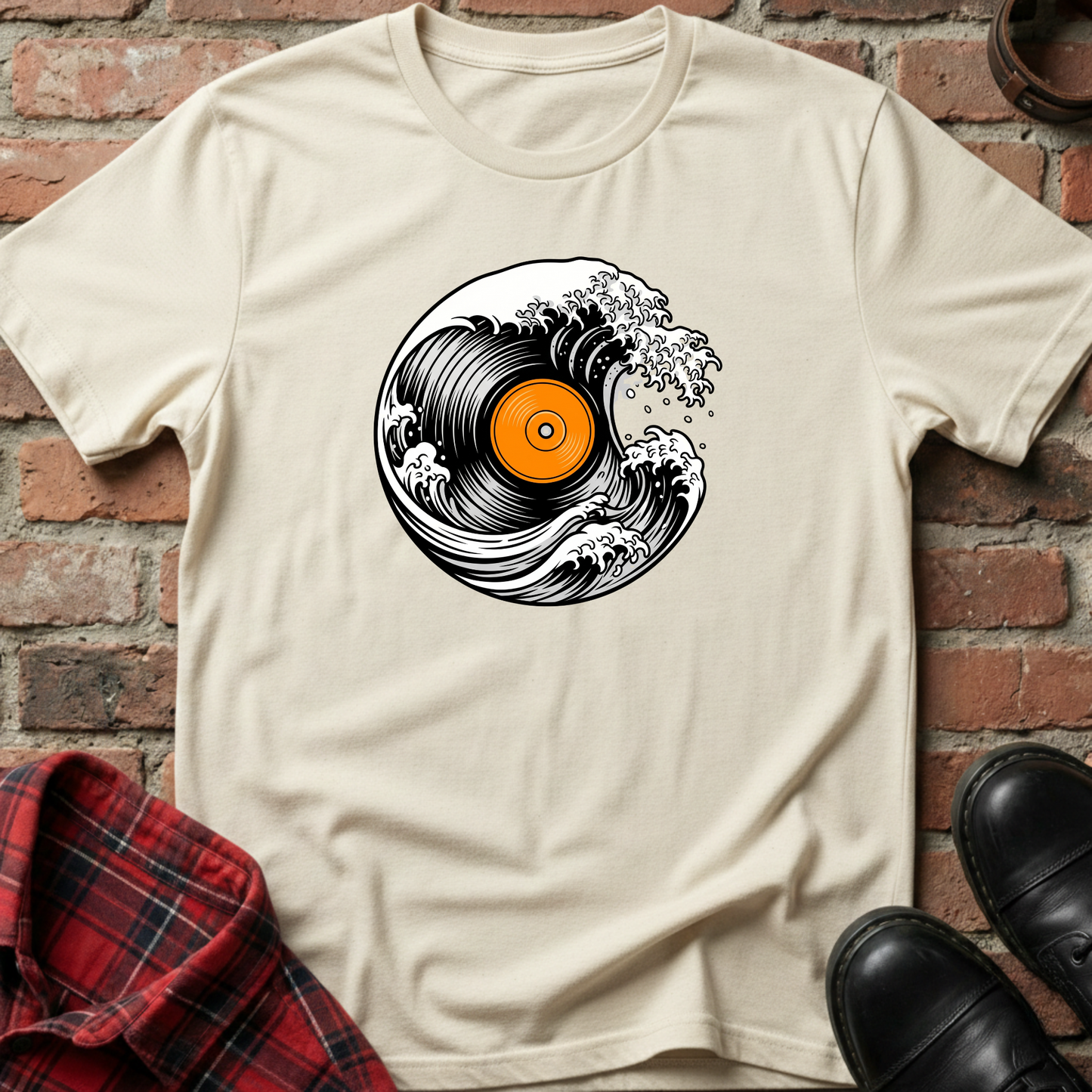 Beige t-shirt with vinyl record design on a brick wall background. Minimalist music apparel by pemuyo.