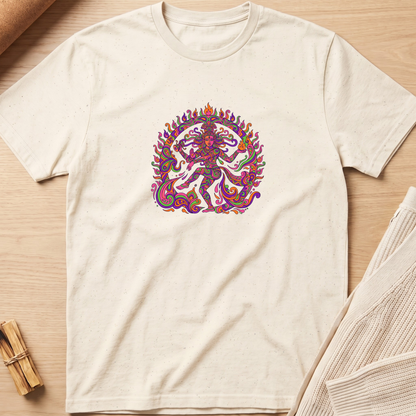 An off-white crewneck t-shirt featuring a colorful, detailed graphic of a dancing Hindu deity (Shiva Nataraja) in the center, laid flat on a light wood background with styled props. Minimalist yoga apparel by pemuyo.