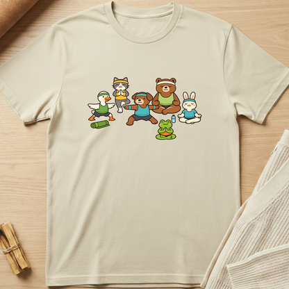 Beige t-shirt with cartoon characters on a wooden surface. Minimalist yoga apparel by pemuyo.