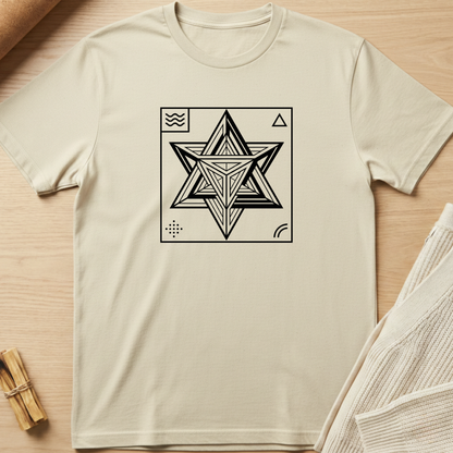 Beige t-shirt with a geometric star design on a wooden surface. Minimalist yoga apparel by pemuyo.