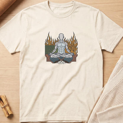 An off-white short-sleeve t-shirt with a graphic of a meditating figure surrounded by flames, laid flat on a light wood background with a small bundle of incense sticks and a folded knit blanket nearby. Minimalist yoga apparel by pemuyo.