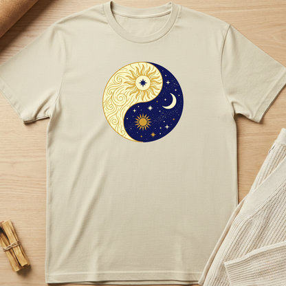 Beige t-shirt with a yin yang design featuring sun and moon on a wooden surface. Minimalist yoga apparel by pemuyo.