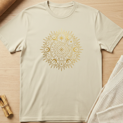 Beige t-shirt with a gold mandala design on a wooden surface. Minimalist yoga apparel by pemuyo.