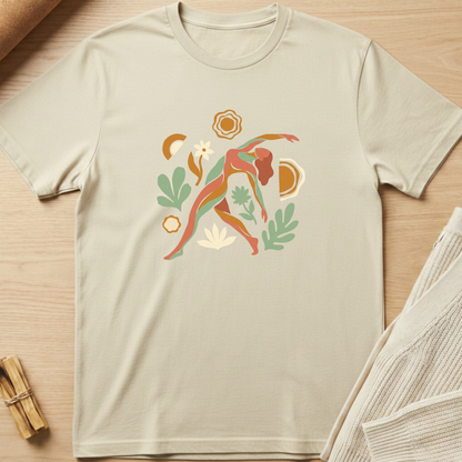 Beige t-shirt with a colorful graphic design on a wooden surface. Minimalist yoga apparel by pemuyo.