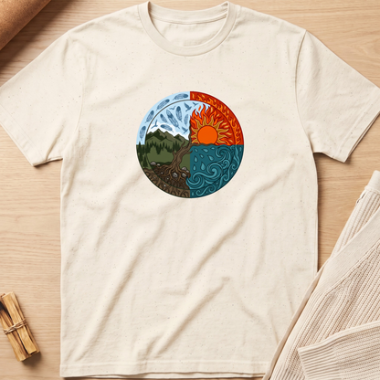 An off-white short-sleeve t-shirt laid flat on a light wood background, featuring a circular graphic of a yin-yang style design with a mountain and forest on one side and a sun over swirling water on the other. Minimalist yoga apparel by pemuyo.