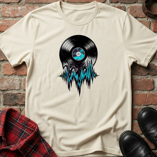 Beige t-shirt with vinyl record design on a brick wall background. Minimalist music apparel by pemuyo.