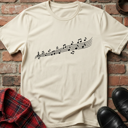 Beige t-shirt with a graphic of headphones on a brick wall background. Minimalist music apparel by pemuyo.