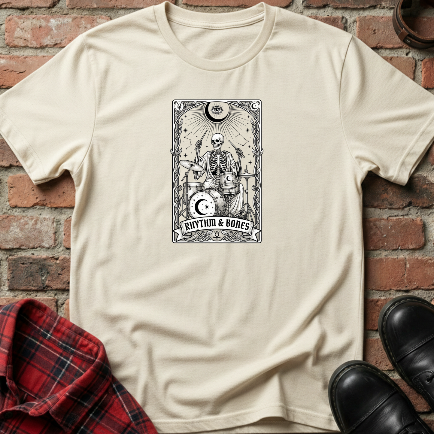 Beige t-shirt with skeleton design and 'Rhythm & Bones' text against a brick wall. Minimalist music apparel by pemuyo.